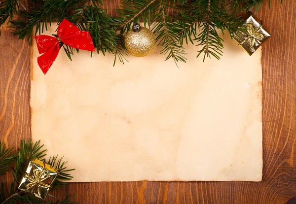 Rustic paper with small Christmas decorations — Stock Photo, Image