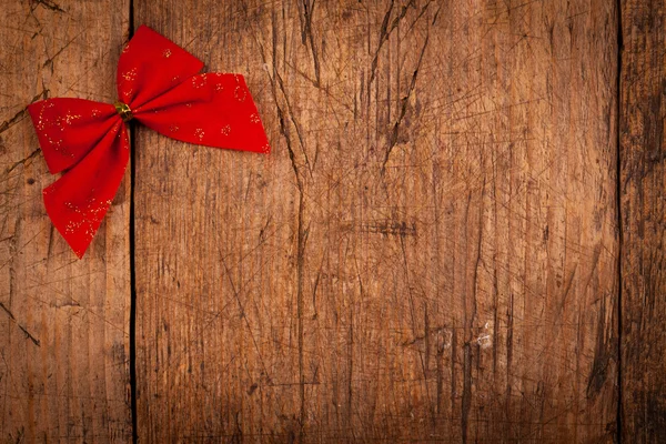 Cinta roja pequeña sobre fondo de madera —  Fotos de Stock