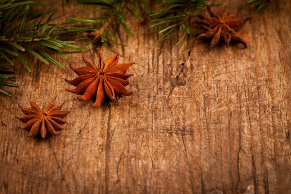 Star anise and branch on wooden background — Stock Photo, Image