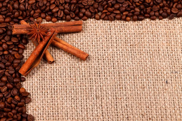 Spices with coffee beans on burlap — Stock Photo, Image