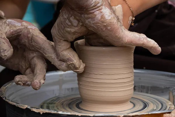 Master class on modeling of clay on a potter\'s wheel In the pottery workshop.
