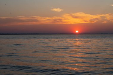 Gölün üzerinde güzel kırmızı ve orangutan gün batımı.
