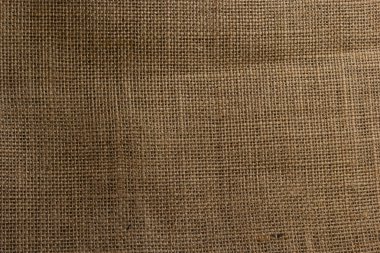 Çuval bezi tekstil soyut doku açık kahverengi krem sarı bej toprak renk tonu.