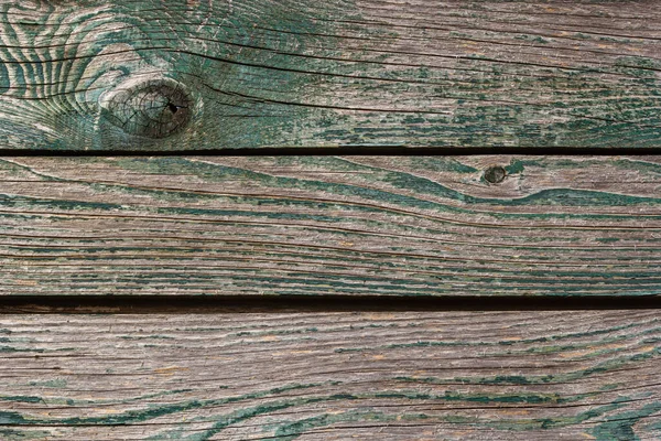 Ahşap zemin, eski ahşap duvar, maviye boyanmış, yarıklar ve çivilerle..