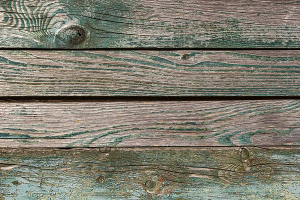 Ahşap zemin, eski ahşap duvar, maviye boyanmış, yarıklar ve çivilerle..