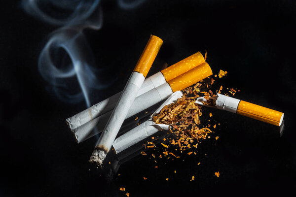 Cigarette smoking closeup isolated on balck background. No smoking concept.