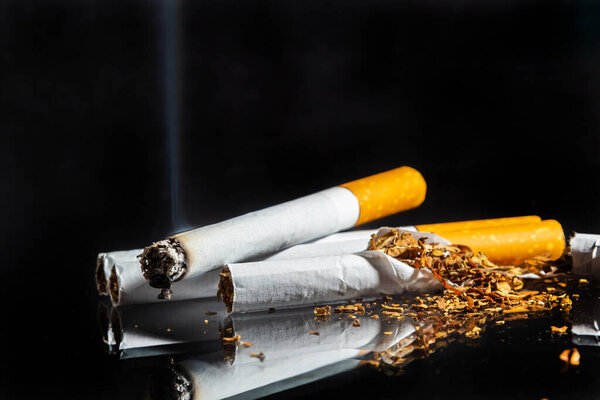 Cigarette smoking closeup isolated on balck background. No smoking concept.