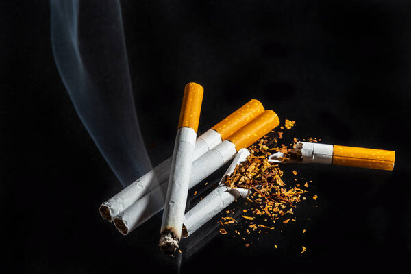 Cigarette smoking closeup isolated on balck background. No smoking concept.