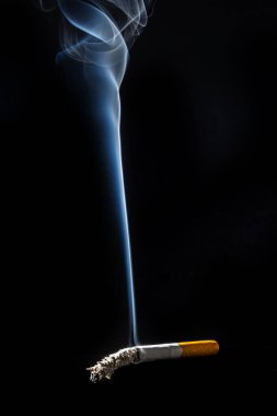 Cigarette smoking closeup isolated on balck background. No smoking concept.