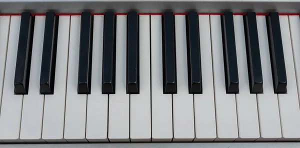 close-up of piano keys. close frontal view, black and white piano keys, viewed from above.