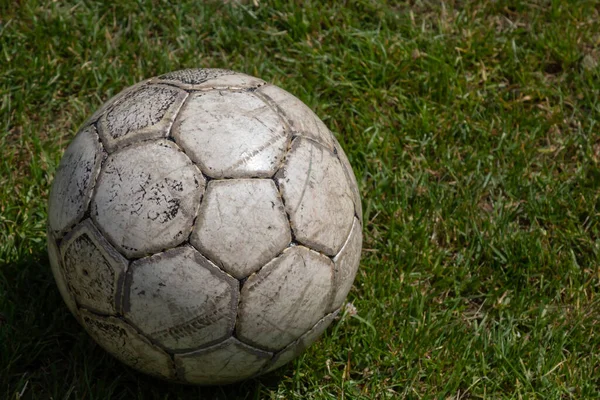 Soccer ball on green grass of football field with copy space.