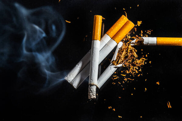 Cigarette smoking closeup isolated on balck background. No smoking concept.