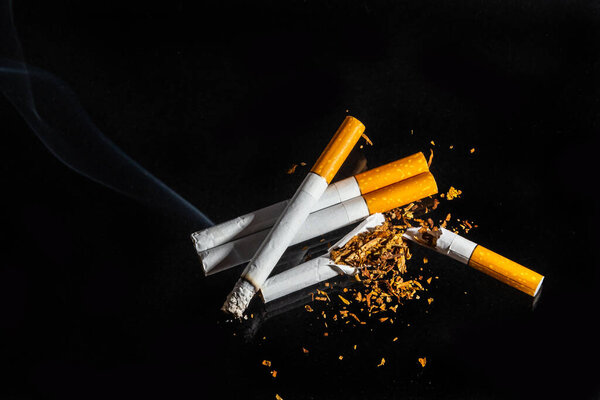 Cigarette smoking closeup isolated on balck background. No smoking concept.