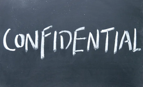 Confidential sign written with chalk on blackboard — Stock Photo, Image