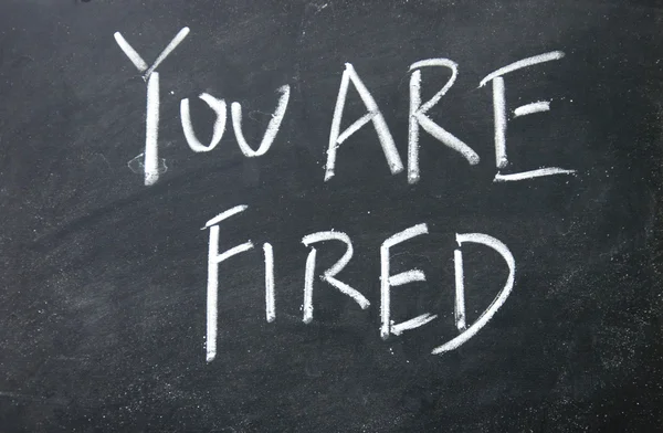 You are fired title written with chalk on blackboard — Stock Photo, Image