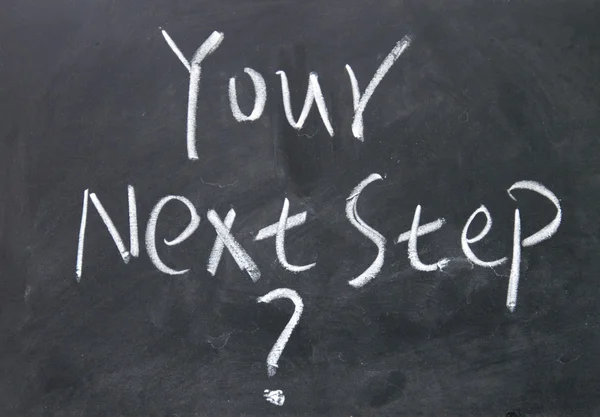 Your next step sign written with chalk on blackboard — Stock Photo, Image