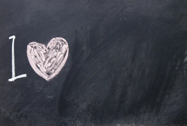 Love sign drawn with chalk on blackboard — Stock Photo, Image