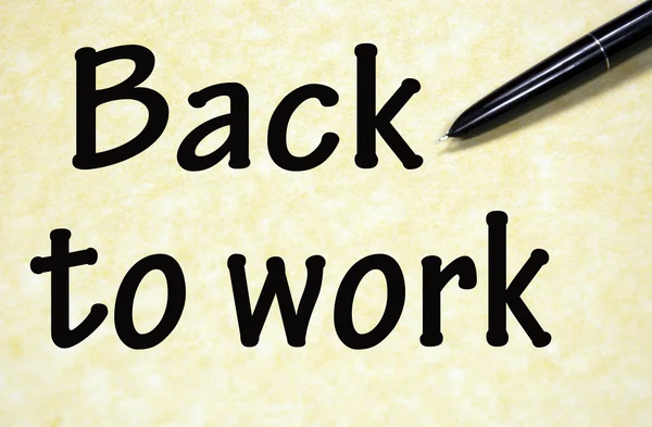 back to work title written with pen on paper