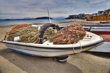 Boats pulled dry on the beach of saint peter island of ischia clipart