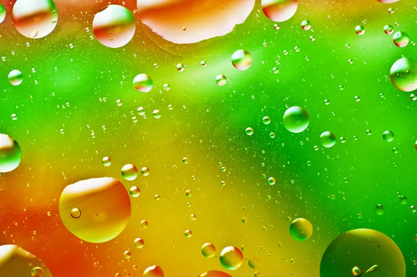 Oil-drops floating in water — Stock Photo, Image