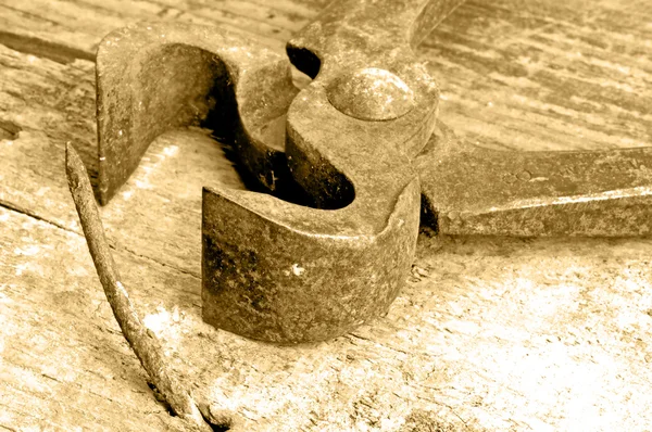 Old rusty pliers with nail — Stock Photo, Image