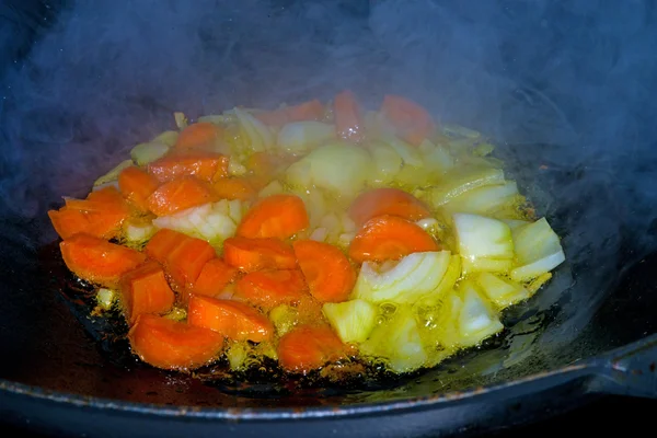 Chinese wok with carrots and onions — Stock Photo, Image