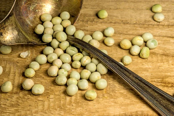 Peas with a spoon — Stock Photo, Image