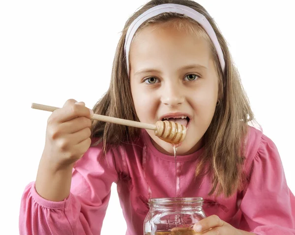 Niña comer miel — Foto de Stock