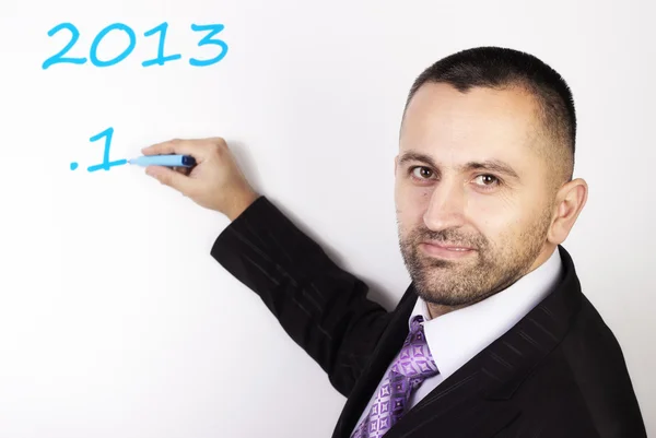 Young man in a suit writing — Stock Photo, Image