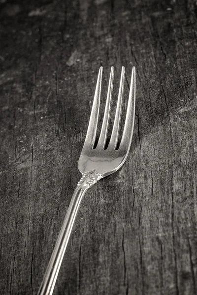 Single fork on old wooden plank — Stock Photo, Image