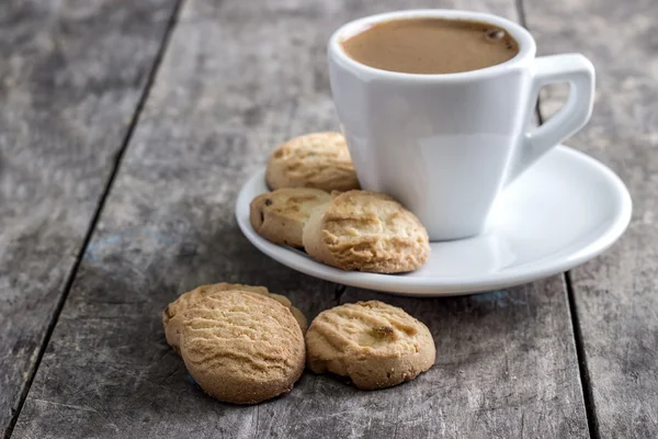 Чашка кофе и печенье на столе — стоковое фото