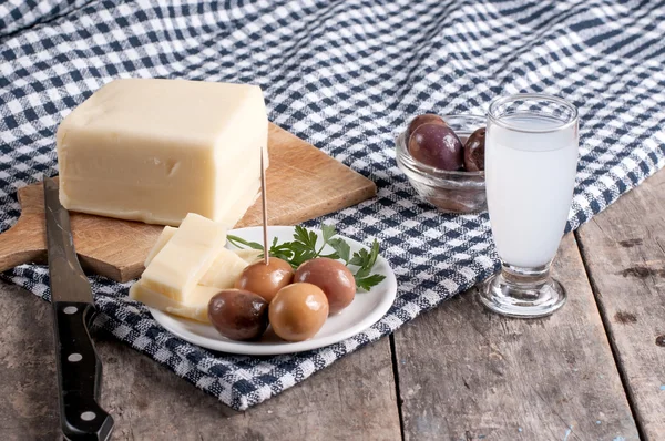 Вкусный сыр и оливки на столе — стоковое фото