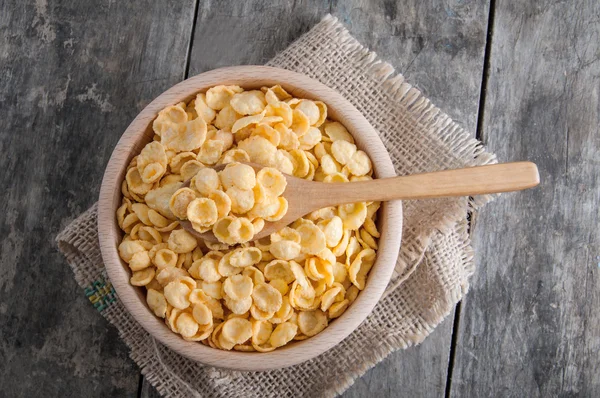 Cornflakes in a wooden bowl — Stock Photo, Image