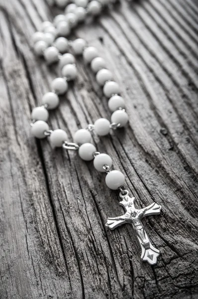 Rosary on old wooden background — Stock Photo, Image