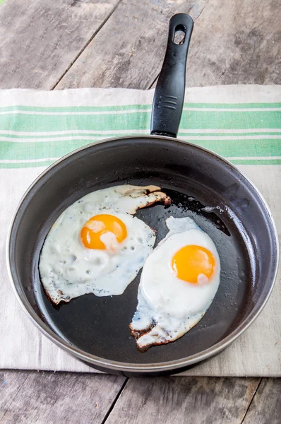 Fried eggs in a pan — Stock Photo, Image