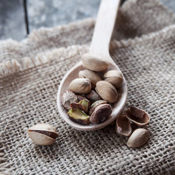 Dried Pistachio Nuts In A Wooden spoon — Stock Photo, Image