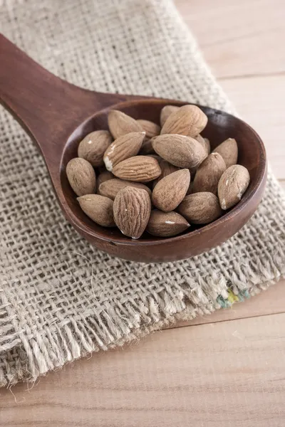 Almonds kernel in awooden spoon — Stock Photo, Image