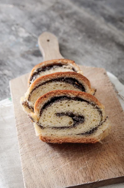 Poppy seed Roll on a wooden surface — Stock Photo, Image