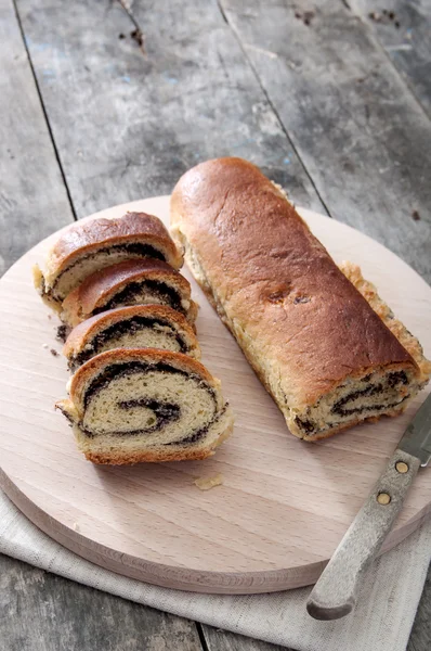 Poppy seed Roll on a wooden surface — Stock Photo, Image