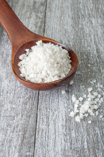 Sea salt in a wooden spoon — Stock Photo, Image