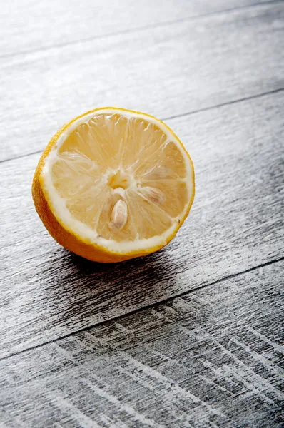 Half Lemon on old wooden table — Stock Photo, Image
