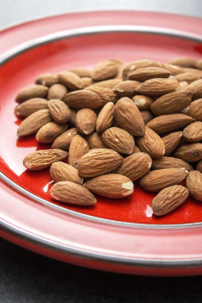 Raw almonds in plate — Stock Photo, Image