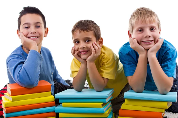 Boys with piles of books — Stockfoto