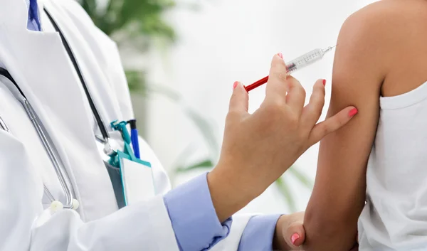 Female doctor making injection to little boy — Stock Photo, Image