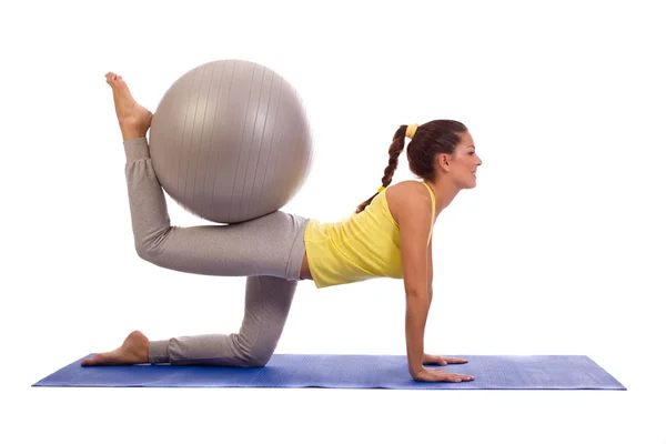 Attractive woman exercising with exercise ball — Stock Photo, Image