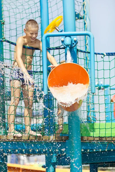 Little boy having fun in aqua park — Stock Photo, Image