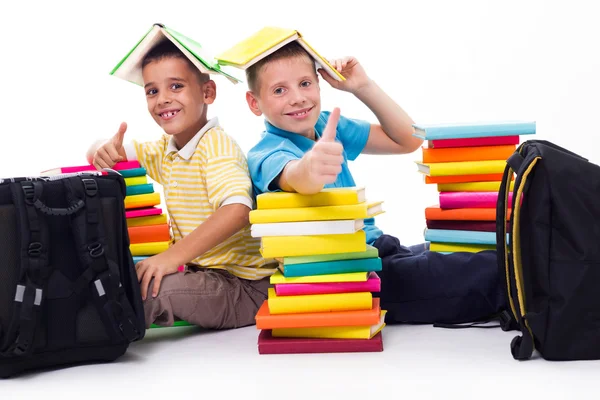 Boys with piles of books — Stok fotoğraf