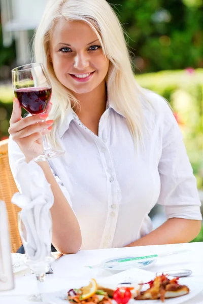 Young happy woman with glass of redwine — Stockfoto