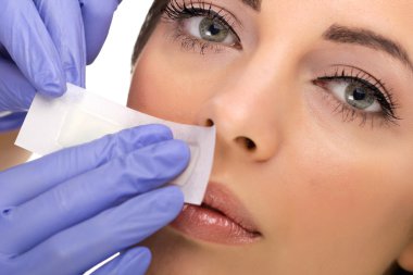 woman reciving facial epilation clipart