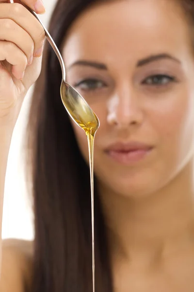 Woman holding spoon with honey — Stock Photo, Image